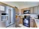 Well-equipped kitchen featuring wooden cabinets, stainless steel appliances, and a sleek countertop at 6826 S 16Th Way, Phoenix, AZ 85042