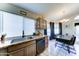 Kitchen and dining area featuring wooden cabinets, black appliances, and a sleek countertop at 6826 S 16Th Way, Phoenix, AZ 85042
