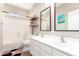 Bright bathroom featuring double sinks, plank flooring, floating shelves, and a shower-tub combo at 6870 S Crestview Dr, Gilbert, AZ 85298
