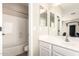 Clean bathroom featuring modern fixtures, white cabinetry, plank flooring and a shower-tub combo at 6870 S Crestview Dr, Gilbert, AZ 85298