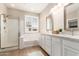 Bright bathroom features double sinks, wood floors, large window, a separate shower, and a soaking tub at 6870 S Crestview Dr, Gilbert, AZ 85298