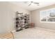 Well-lit bedroom featuring plantation shutters, neutral walls, and a tall bookcase perfect for storage at 6870 S Crestview Dr, Gilbert, AZ 85298