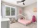 Whimsical bedroom designed with a pink bed frame, rainbow decor, and a playful ambiance at 6870 S Crestview Dr, Gilbert, AZ 85298