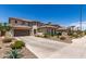 Two-story beige home with a long driveway, tile roof, and desert landscaping at 6870 S Crestview Dr, Gilbert, AZ 85298