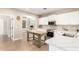 Bright kitchen with white cabinets, quartz countertops, and wood-style floors at 6870 S Crestview Dr, Gilbert, AZ 85298