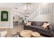Open concept living space with high ceilings, a gray sofa, and wood-style floors at 6870 S Crestview Dr, Gilbert, AZ 85298