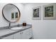 Stylish bathroom with round mirror, modern fixtures, and marble countertop at 7137 E Rancho Vista Dr # 6011, Scottsdale, AZ 85251