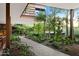 A beautiful, landscaped courtyard with a brick walkway that is surrounded by lush greenery and colorful plants at 7137 E Rancho Vista Dr # 6011, Scottsdale, AZ 85251