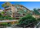 Multi-story condo building featuring balconies with lush plants and an inviting courtyard with mature trees at 7137 E Rancho Vista Dr # 6011, Scottsdale, AZ 85251