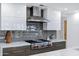This kitchen features a Wolf range, subway tile backsplash, and custom cabinets at 7137 E Rancho Vista Dr # 6011, Scottsdale, AZ 85251