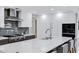 Modern kitchen with stainless steel appliances, a large island, and sleek white cabinetry at 7137 E Rancho Vista Dr # 6011, Scottsdale, AZ 85251