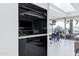 The kitchen features a stainless steel Wolf oven, and open concept to dining area at 7137 E Rancho Vista Dr # 6011, Scottsdale, AZ 85251