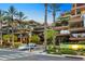 Exterior view of multi-story condos surrounded by palm trees, landscaping, and a street with crosswalk at 7137 E Rancho Vista Dr # 6011, Scottsdale, AZ 85251