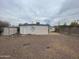 Exterior view of home and gravel backyard, featuring an external storage shed on the side at 7139 E Arcadia Cir, Mesa, AZ 85208