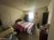 Cozy bedroom with a striped bedspread, functional closet, and a window for natural light at 7139 E Arcadia Cir, Mesa, AZ 85208