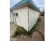 View of the home's back exterior showing weathered siding and an external air conditioning unit at 7139 E Arcadia Cir, Mesa, AZ 85208