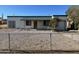 Charming single-story home with a fenced front yard, green roof and a one car garage at 7139 E Arcadia Cir, Mesa, AZ 85208