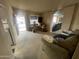 Living room with carpet flooring, front door, an archway and adjacent room, showing worn carpet at 7139 E Arcadia Cir, Mesa, AZ 85208
