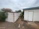 Backyard view of an external storage shed and the home's exterior, yard is rock covered at 7139 E Arcadia Cir, Mesa, AZ 85208