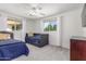 Bright bedroom featuring twin beds, light gray walls, and a ceiling fan for added comfort at 7727 E 4Th St, Scottsdale, AZ 85251