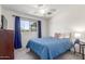 Light bedroom with ceiling fan and a large window at 7727 E 4Th St, Scottsdale, AZ 85251