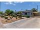 Attractive single-story home with a long driveway, desert landscaping, and a shaded carport at 7727 E 4Th St, Scottsdale, AZ 85251