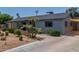 Stylish home with desert landscaping, a driveway, and carport, offering practical and aesthetic appeal at 7727 E 4Th St, Scottsdale, AZ 85251