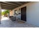 Covered front porch with seating area, offering a welcoming and relaxing outdoor space at 7727 E 4Th St, Scottsdale, AZ 85251