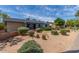 Well-maintained front yard with desert landscaping and mature trees providing shade and curb appeal at 7727 E 4Th St, Scottsdale, AZ 85251
