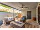 Inviting covered patio featuring a gas firepit and comfortable wicker seating, perfect for outdoor gatherings at 7727 E 4Th St, Scottsdale, AZ 85251