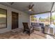 Cozy covered patio with a gas firepit, comfortable seating, and a ceiling fan at 7727 E 4Th St, Scottsdale, AZ 85251