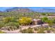 Scenic aerial view of a desert home with mountain views, showcasing its desert landscaping and neighborhood at 8300 E Lone Mountain Rd, Scottsdale, AZ 85266