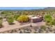 Expansive aerial view of a home in a desert landscape, surrounded by trees and native vegetation at 8300 E Lone Mountain Rd, Scottsdale, AZ 85266