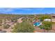 Overhead aerial of estate, featuring beautiful desert vegetation, pool with lounge area, and mountain views at 8300 E Lone Mountain Rd, Scottsdale, AZ 85266