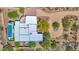 Dramatic aerial view of modern estate and pool highlighting desert landscaping and scenic driveway at 8300 E Lone Mountain Rd, Scottsdale, AZ 85266