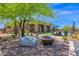 Backyard offers a built-in firepit, outdoor seating, manicured landscape, and a pool at 8300 E Lone Mountain Rd, Scottsdale, AZ 85266