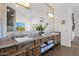 Bathroom with double sinks, custom wood cabinets, granite counters, and large mirror at 8300 E Lone Mountain Rd, Scottsdale, AZ 85266