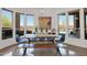 Bright dining area with a view of the outdoor pool, stylish chandelier, and lots of light at 8300 E Lone Mountain Rd, Scottsdale, AZ 85266