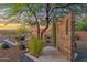 This backyard boasts desert landscaping with mature trees, a brick wall and an outdoor shower at 8300 E Lone Mountain Rd, Scottsdale, AZ 85266