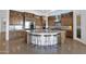 Gourmet kitchen featuring a large center island with seating and wooden cabinets at 8300 E Lone Mountain Rd, Scottsdale, AZ 85266