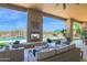 Relaxing outdoor area featuring a fireplace, comfortable seating, and a view of the pool at 8300 E Lone Mountain Rd, Scottsdale, AZ 85266