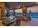 Inviting outdoor living space featuring a fireplace, comfortable seating, and pool views at 8300 E Lone Mountain Rd, Scottsdale, AZ 85266