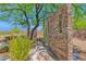 Outdoor shower features decorative stone wall, desert landscape, and mature trees at 8300 E Lone Mountain Rd, Scottsdale, AZ 85266