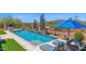 Backyard pool with desert landscaping, mountain views, and lounge seating at 8300 E Lone Mountain Rd, Scottsdale, AZ 85266