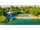Aerial view of a luxurious backyard featuring a large pool, lush landscaping, and waterfront access at 8312 N Golf Dr, Paradise Valley, AZ 85253