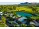 Aerial view of a beautiful residential area featuring lush green spaces, water features, and well-maintained homes at 8312 N Golf Dr, Paradise Valley, AZ 85253