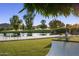 Lush backyard with a pond, golf course, hammock, lounge chairs, and beautiful mountain views at 8312 N Golf Dr, Paradise Valley, AZ 85253