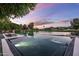 Stunning backyard oasis with a modern pool overlooking a picturesque golf course and a colorful sky at 8312 N Golf Dr, Paradise Valley, AZ 85253