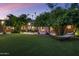 A lush backyard offers a serene escape with manicured lawn and mature landscaping at 8312 N Golf Dr, Paradise Valley, AZ 85253