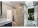 Bright bathroom with natural light, walk-in shower, and modern gray tile and cabinets at 8312 N Golf Dr, Paradise Valley, AZ 85253